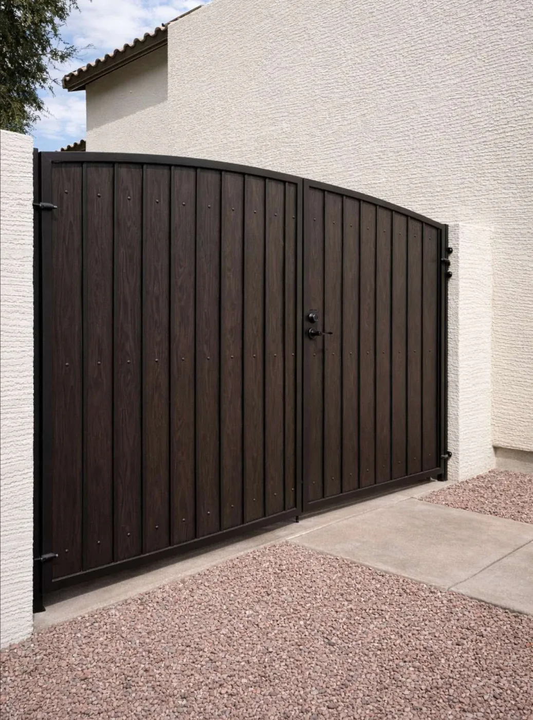 Dark metal entry gate on a side yard