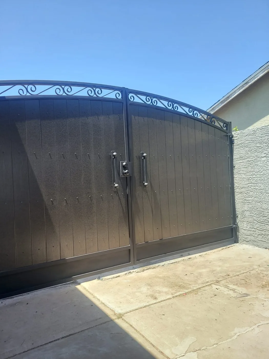 Arched double gate at a garage entry