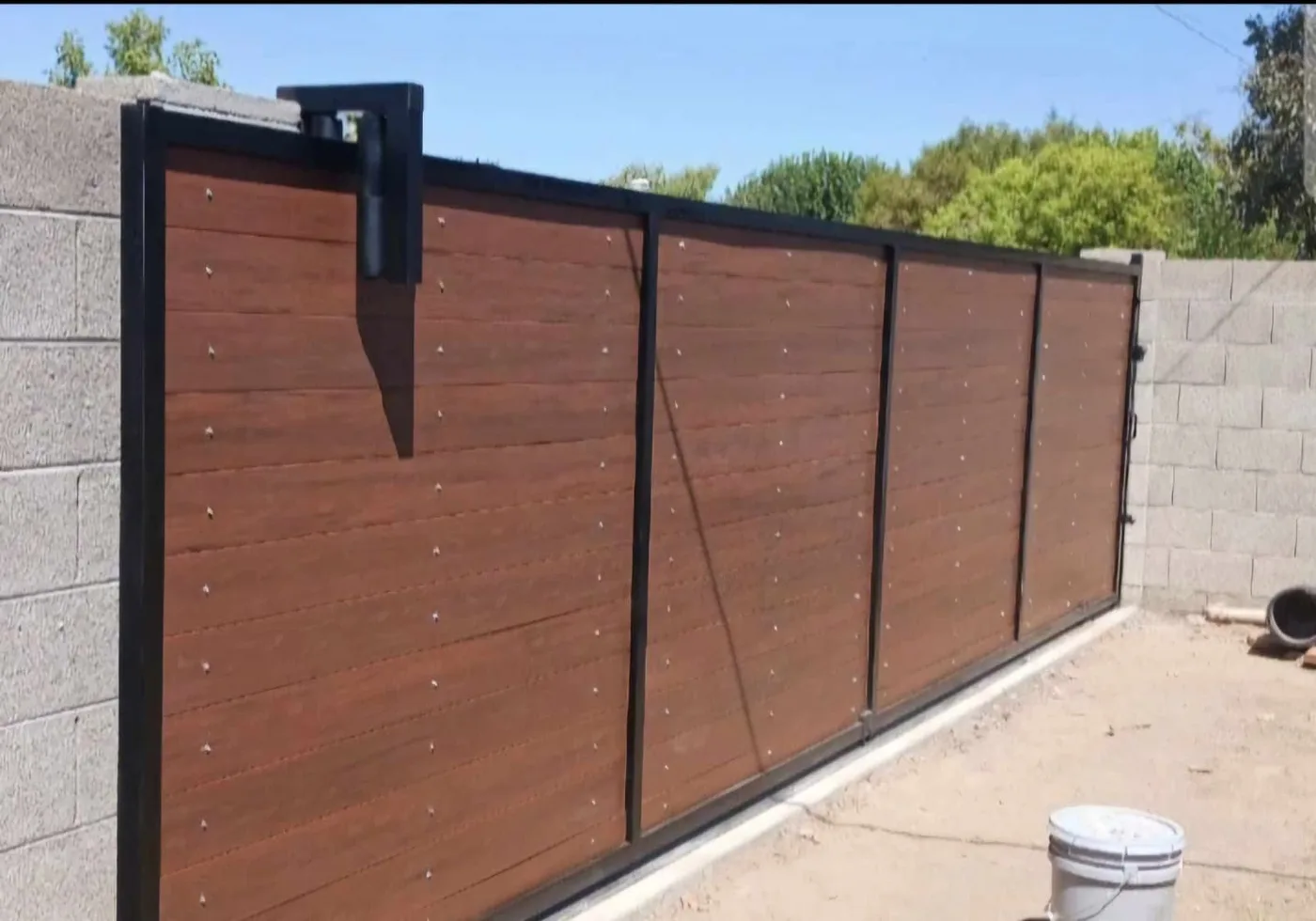 Long sliding driveway gate in wood and steel